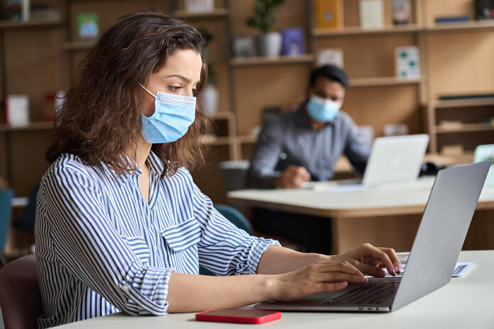 Latin Girl Student Wearing Face Mask Studying On Laptop. Hispani