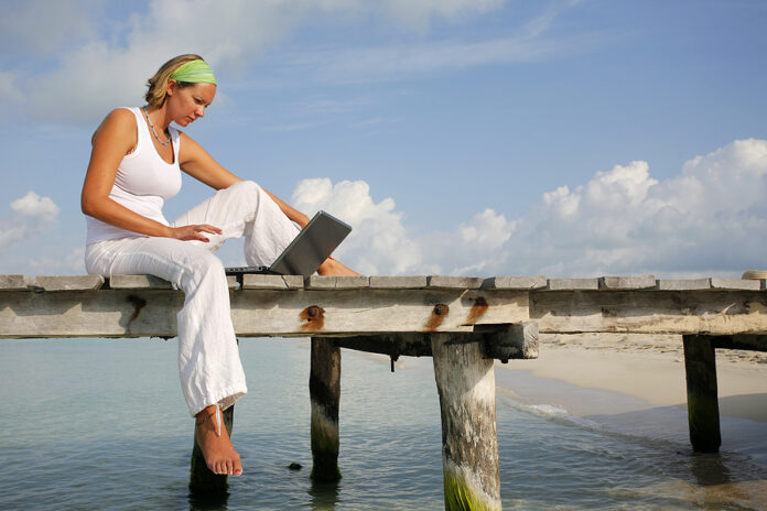 Woman On Jetty With Laptop