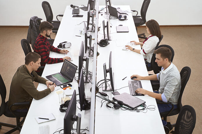 Young Professionals Working In Modern Office. Group Of Developer