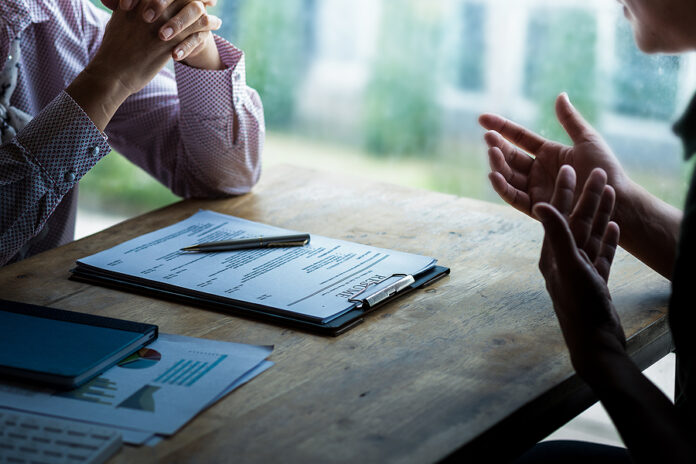 Interviewer Reading A Resume, Person Submits Job Application, Pe