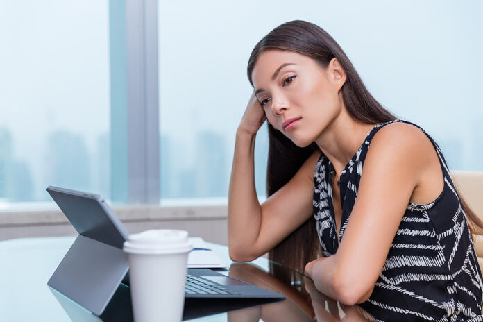 Bored or sad woman working at office job. Negative work concept.