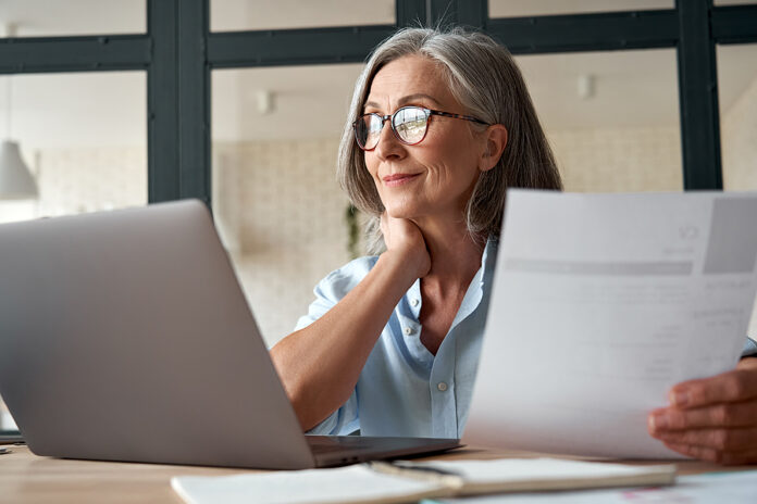 Smiling Mature Middle Aged Business Woman Using Laptop Working O