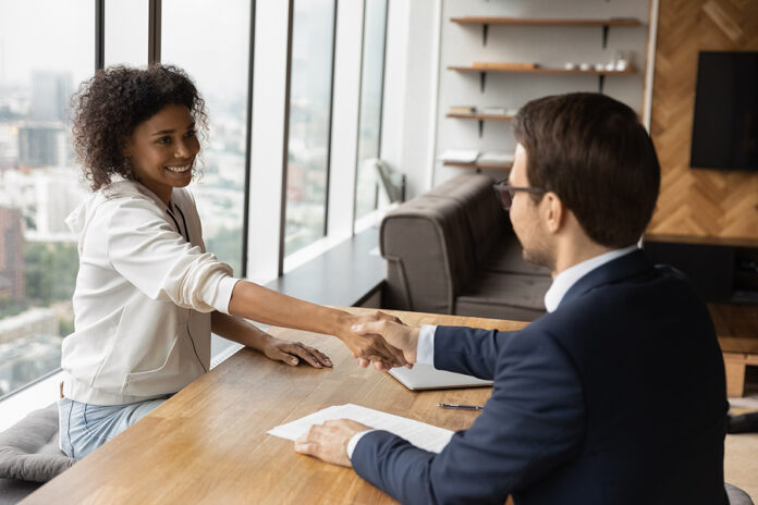 Young Female African American Job Seeker Shaking Hands With Empl