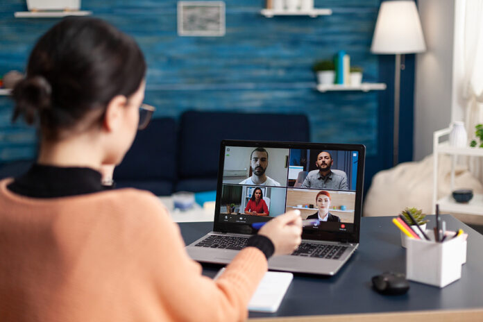 Woman In A Briefing Videocall With Team On Laptop. Freelancer Wo