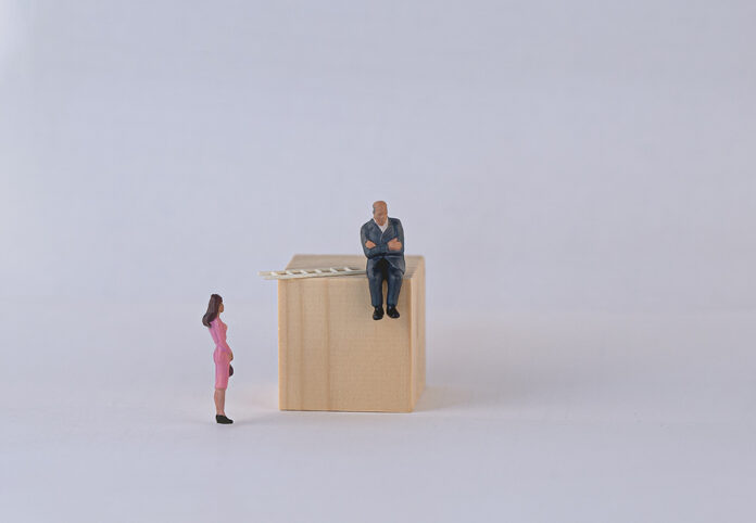Gender Gap. A Man Does Not Let A Woman Climb The Stairs. Concept