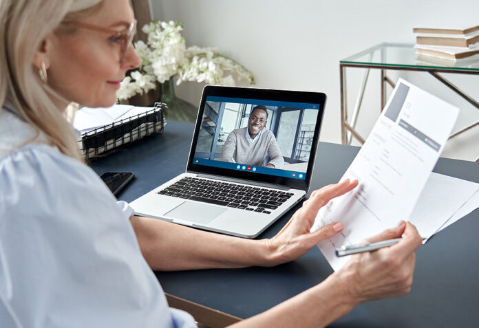 Female Hr Reading Cv During Online Virtual Job Interview By Vide