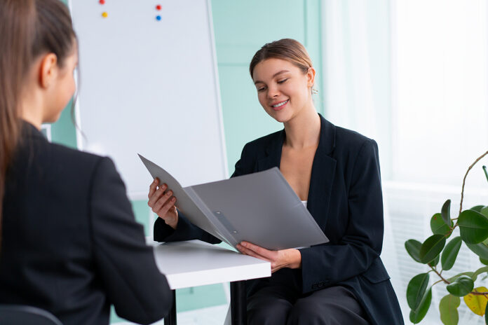 Business Meeting. Young Blonde Woman Holding Contract While Sitt