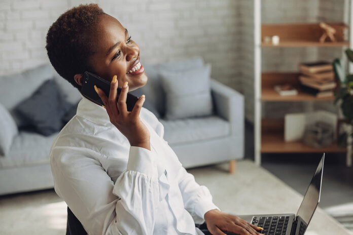 Smiling African-american Business Woman Talking On Phone Using L