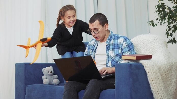 Quarantine. Man A Work Remotely From Home. Child With Plane Prev