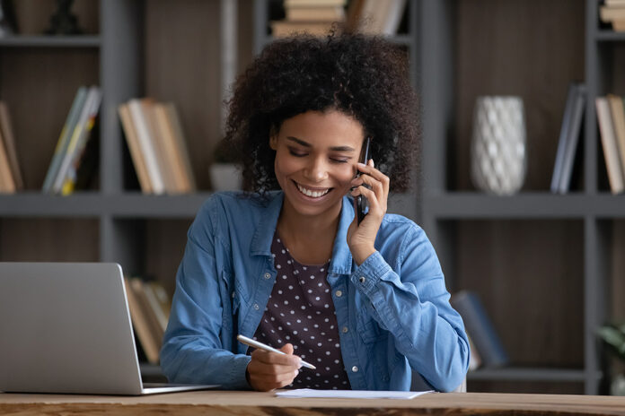 Happy Black Freelance Employee Speaking To Client On Mobile Phon