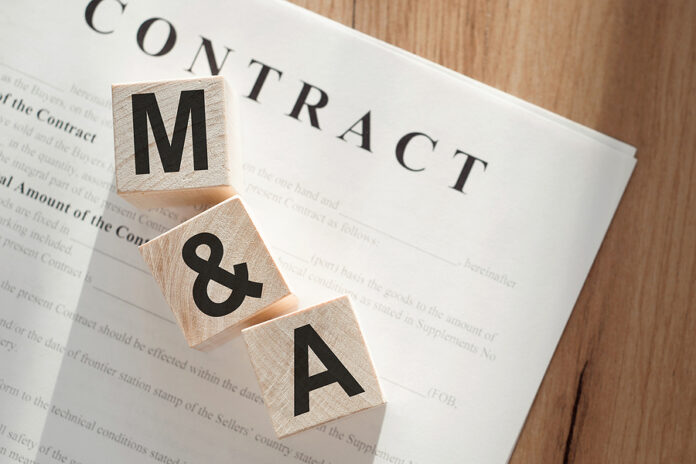 Word M And A Mergers And Acquisitions On Wooden Cubes On Contrac