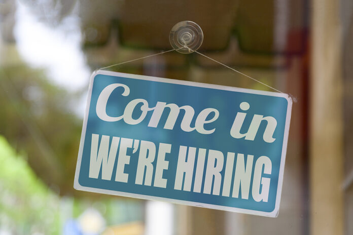 Close-up On A Blue Sign In The Window Of A Shop Displaying The M