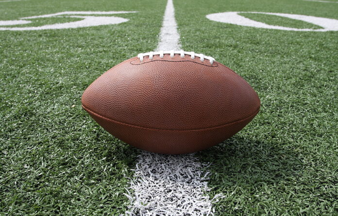 Football near the 50 yard line