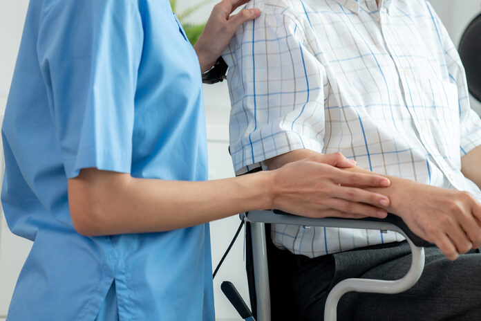 Happy Positive Asian Nurse Giving Support And Touching Contented
