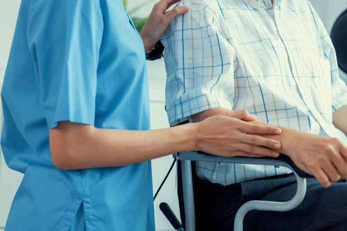 Happy Positive Asian Nurse Giving Support And Touching Contented