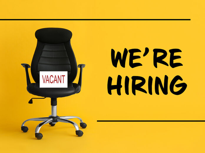 Black Office Chair With Sign Vacant And Text We`re Hiring On Yel