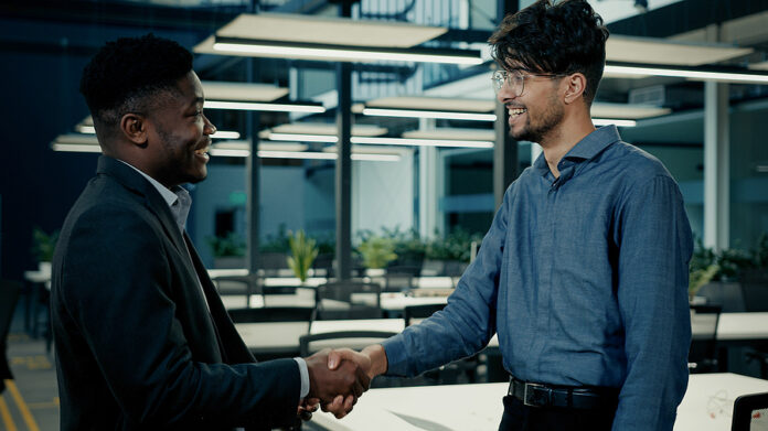 Business Meeting Two Colleagues Men Shake Hands At Office Accept