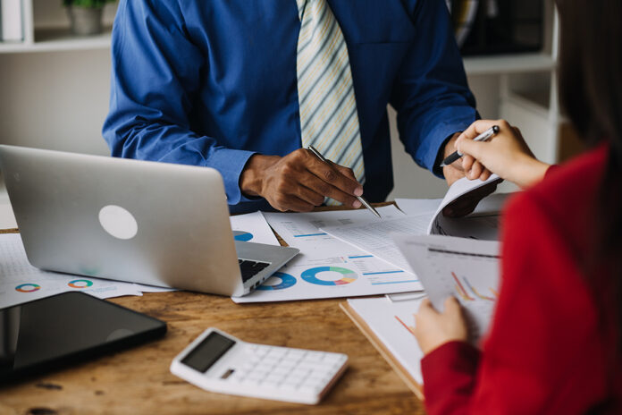 Financial Analysts Analyze Business Financial Reports On A Digit
