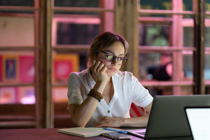 Upset Unhappy Woman Employee Feeling Bored At Workplace, Doing B
