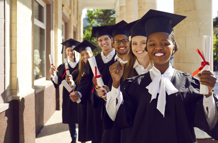 Happy Successful Diverse University Graduates In Caps And Gowns