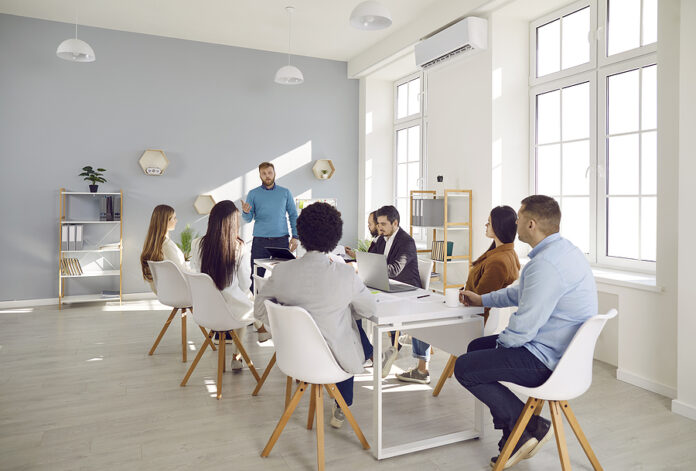 Male Coach Lead Meeting With Diverse Employees