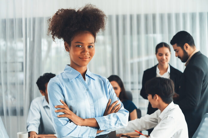 Young African Businesswoman Poses Confidently With Diverse Cowor