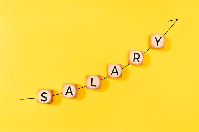 Salary Raise Concept. Rising Arrow And Word On Wooden Blocks On
