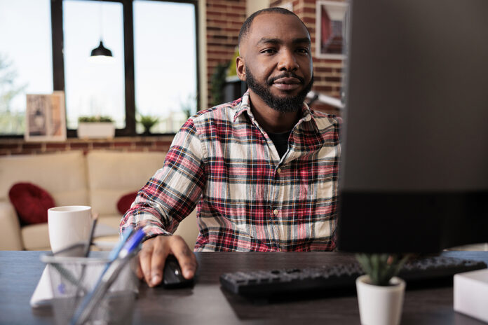 Business Manager Working On Computer At Desk, Analyzing Online D