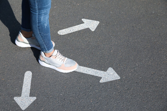 Choice Of Way. Woman Walking To Drawn Mark On Road, Closeup. Whi
