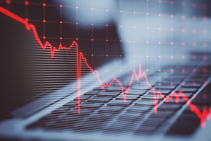 Close Up Of Laptop Keyboard With Falling Red Business Graph Grid