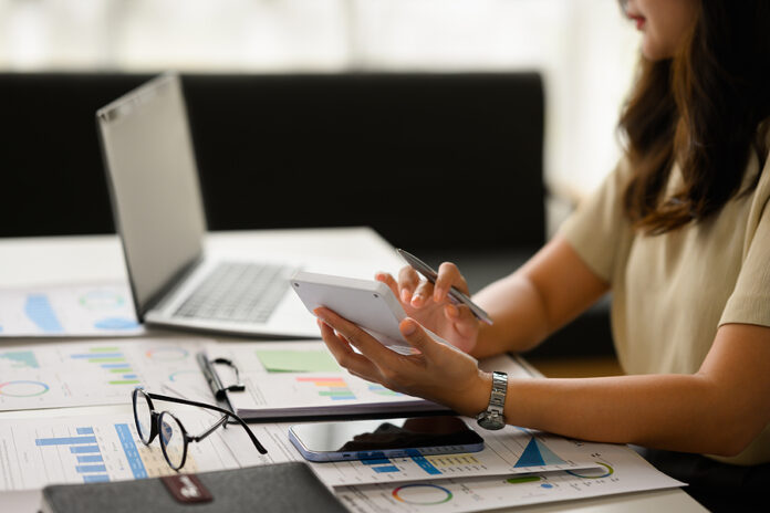 Cropped Shot Of Female Accountant Working Bookkeeping Documents,