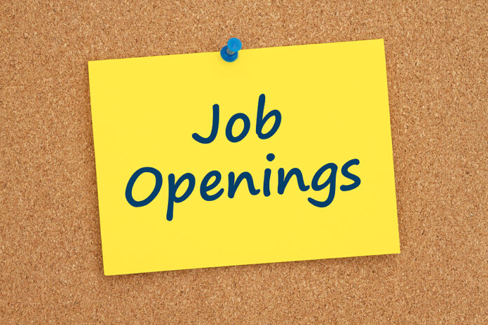Job Openings Message On Yellow Card Note On A Cork Bulletin Boar