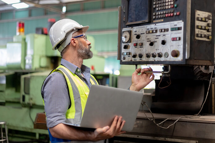 Industrial Man Man Engineer Wear Uniform And Helmet Using Laptop