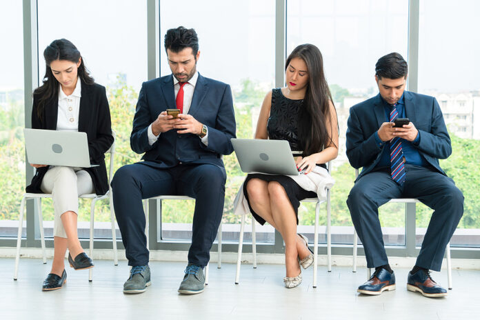 Job Seekers And Applicants Waiting For Interview On Chairs In Of