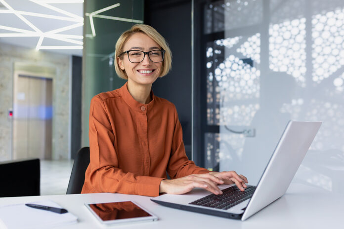 Portrait Of Happy And Successful Female Programmer Inside Office
