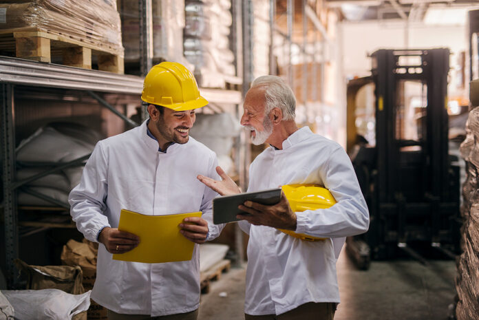 Team Work. Picture Of Two Man Warehouse Employes Smiling And Loo