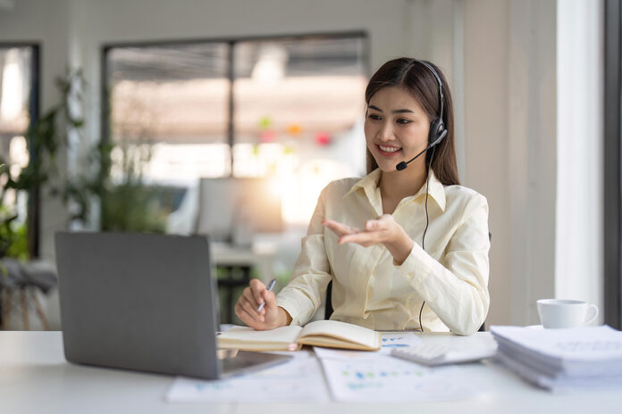 Portrait Of Happy Smiling Female Customer Support Phone Operator
