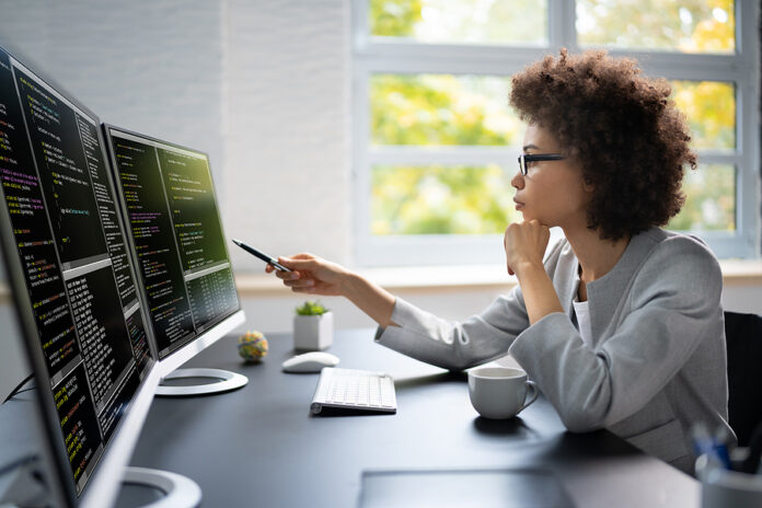 Software Programmer Or Coder Woman Using Office Computer