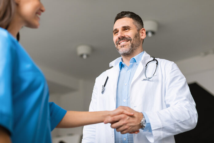 Thank You For Help, Colleague. Happy Male Doctor Shaking Hand Of