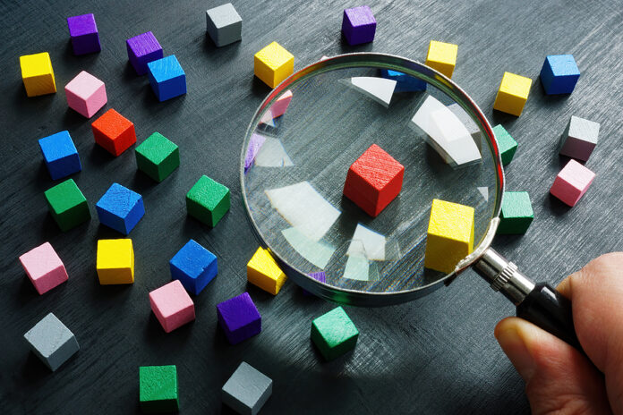 The Hand Is Holding A Magnifying Glass. Talent Acquisition Conce