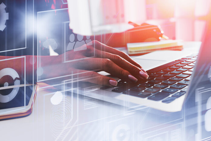 Hands Of Woman Using Laptop In Modern Office With Double Exposur