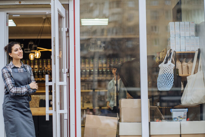Mixed Race Woman Worker Or Store Owner With Standing In The Door