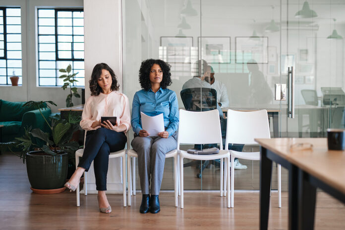 Two Job Applicants Waiting In An Office For Their Interviews