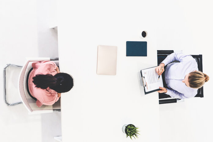 Two Young Business Women In Meeting At Office Table For Job Appl private sector jobs, hiring, job interview