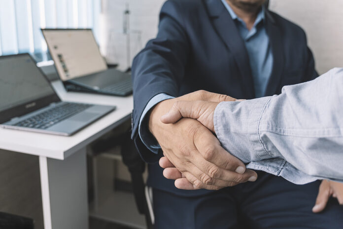 Young Manager Handshake With New Employee. Close-up Handshake. T