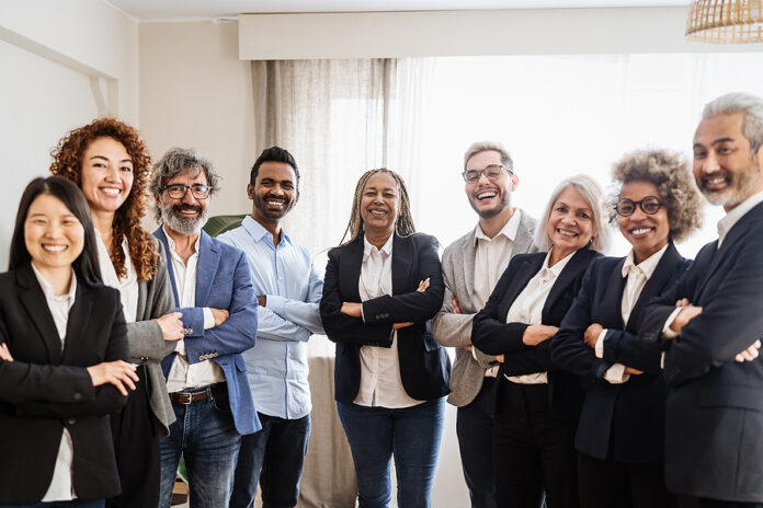 Business Team Of People Standing In Front Of Camera During Meeti