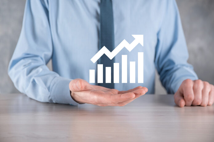 Businessman Man Holding A Graph With Positive Profits Growth. Pl